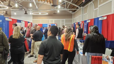 many people standing in a large room decorated in a red, white and blue theme