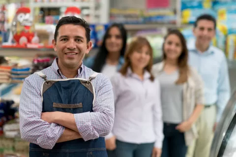 employer with store employees in the background