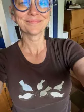 photo of smiling person wearing glasses
