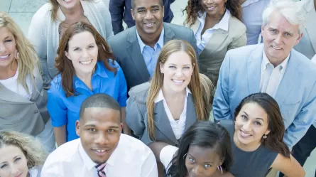 diverse group of employees looking up at the camera