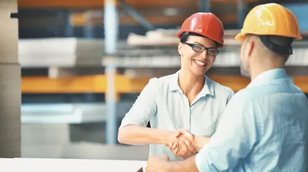Construction workers shaking hands