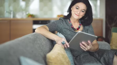 Mature woman smiling looking at laptop