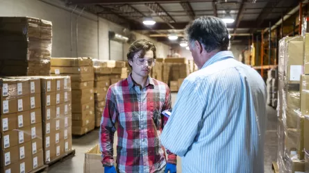 supervisor and young employee in warehouse