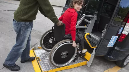 woman in wheelchair getting into van