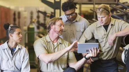 on-the-job training with an instructor and group of mechanic trainees