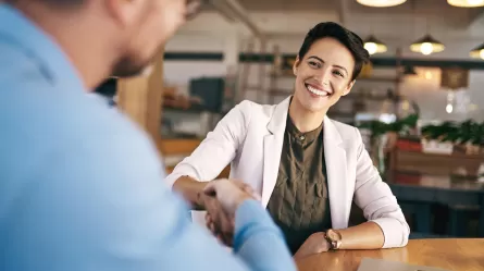 woman shaking hands with employer