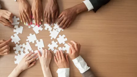 partners putting together puzzle pieces