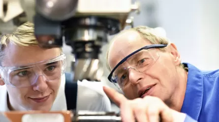 trainee and instructor with manufacturing equipment