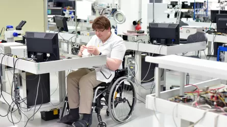man in wheelchair working in high-tech office