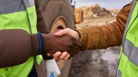 diverse hands, handshake at a construction site