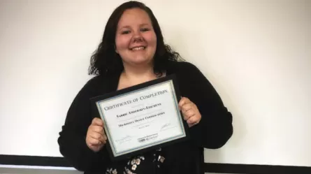 photo of Sabrie with certificate she earned