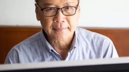 Mature Adult working on a computer. 