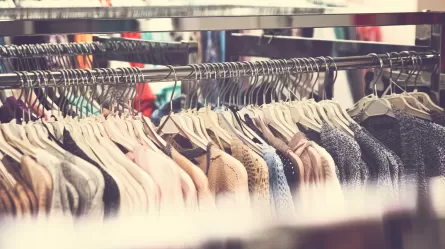 clothing on racks at retail clothing store