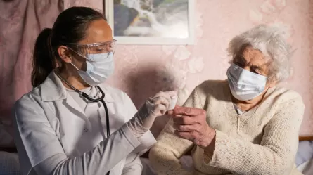 Nursing assistant and patient, both wearing masks