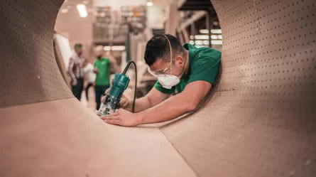 Worker in green shirt wearing a mask