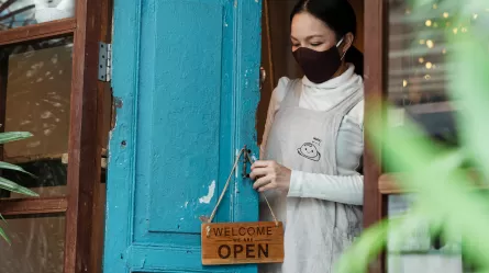 restaurant manager at door of restaurant