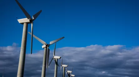 photo of a line of wind turbines against the sky