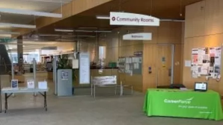 CareerForce Corner in a Minnesota library, with a table covered in a CareerForce branded table topper and CareerForce signs