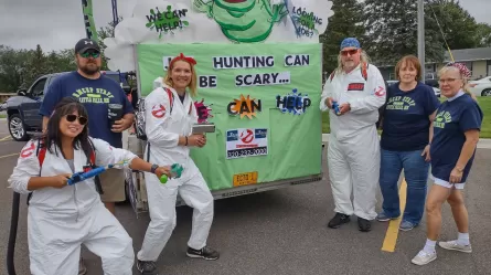 RMCEP staff in front of a truck decorated with a Ghostbusters theme and writing Job Hunting Can Be Scary. Who You Gonna Call? RMCEP 320-232-2000