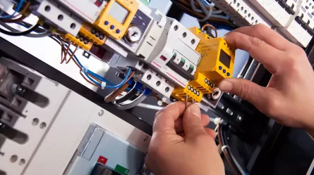 close up of hands of person doing electrical wiring