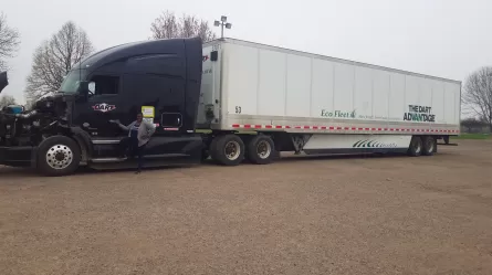 Stacy standing in front of semi truck