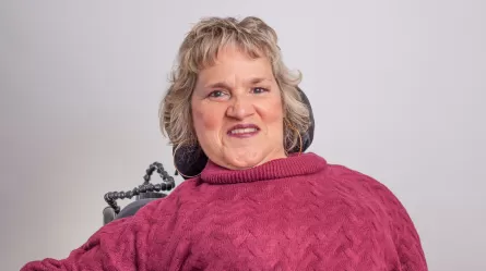 Smiling person in a pink sweater