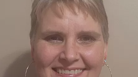 smiling woman with short hair and earings