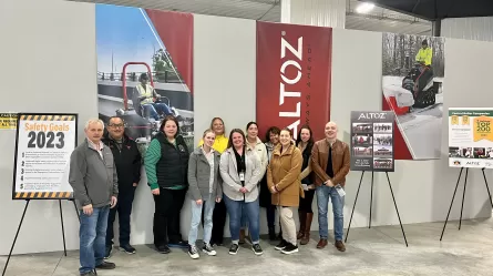 photo of people standing in front of Altoz sign