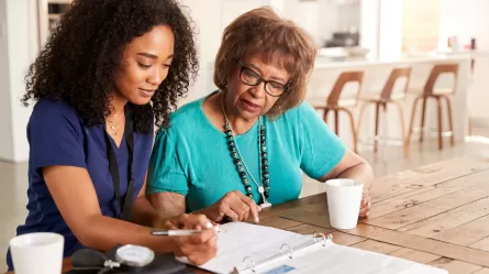 two people looking at a document on a table