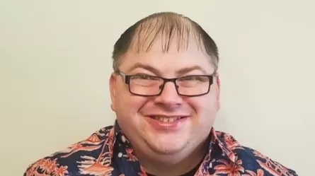 a smiling man wearing glasses