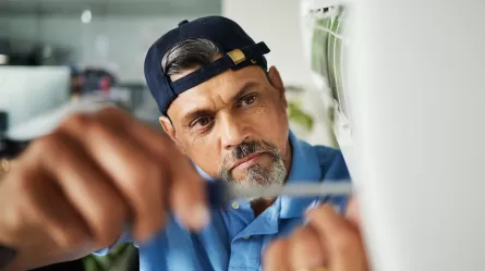 man using a tool to fix something