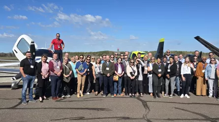 many people standing on top of or next to an airplane