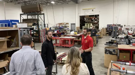 People standing in a large room with tools