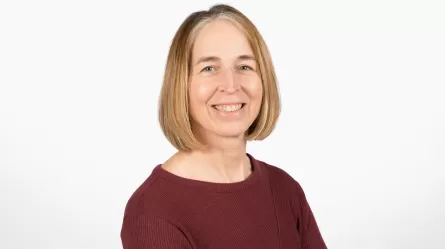 photo of smiling person in maroon shirt