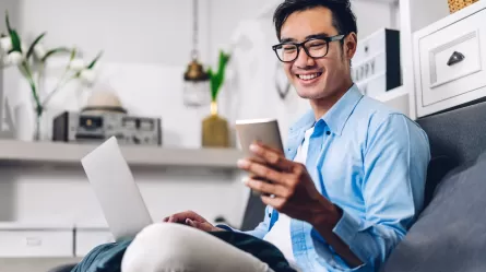 person sitting on a couch looking at a mobile phone