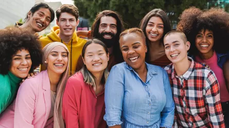 photo of several people standing together and smiling 