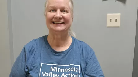 photo of smiling person wearing a blue t-shirt with the words 'Minnesota Valley Action Council'