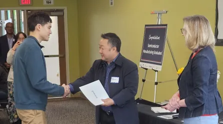 Daniel receiving certificate at Hired Drive for 5 Semiconductor Manufacturing graduation 