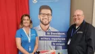 two people standing in front of a banner that says Donaldson Company