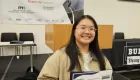 photo of smiling person wearing glasses holding a certificate