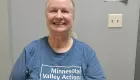 photo of smiling person wearing a blue t-shirt with the words 'Minnesota Valley Action Council'