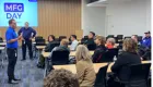 photo of a person presenting to a large room of people