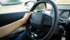photo of hand on car steering wheel