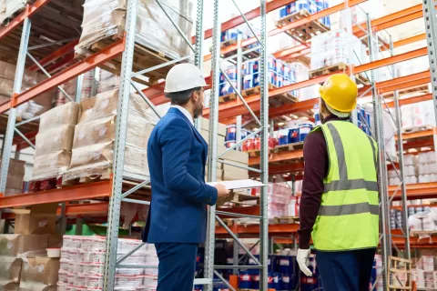 employer at warehouse with employee