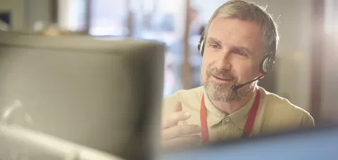 mature CareerForce specialist on the phone helping a caller