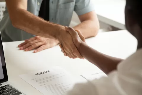 employer and employee shaking hands