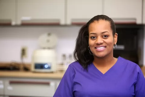 picture of woman in scrubs in health care setting