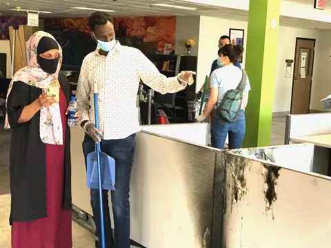 Hamse Warfa joins others in cleaning up CareerForce Minneapolis - South after vandalism and fire