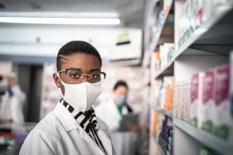 Pharmacy worker wearing a mask