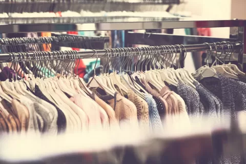 clothing on racks at retail clothing store